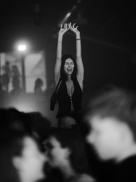 A guest with raised arms on the UNITED dance floor.