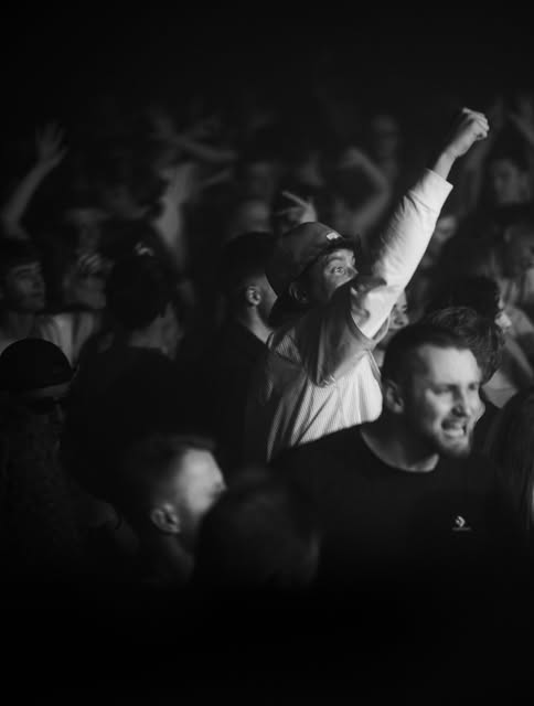 Smiling guests in a crowded UNITED dance floor.